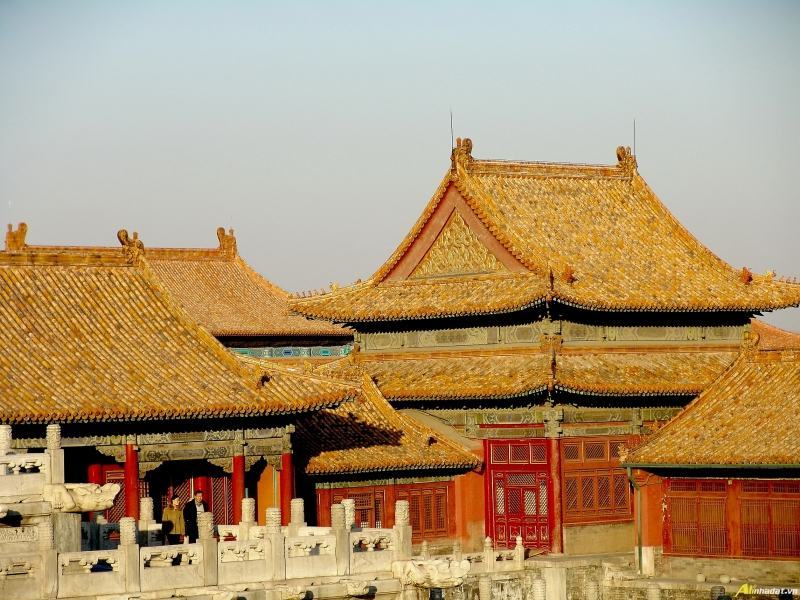 Most of the roofs are covered with yellow glazed tiles.