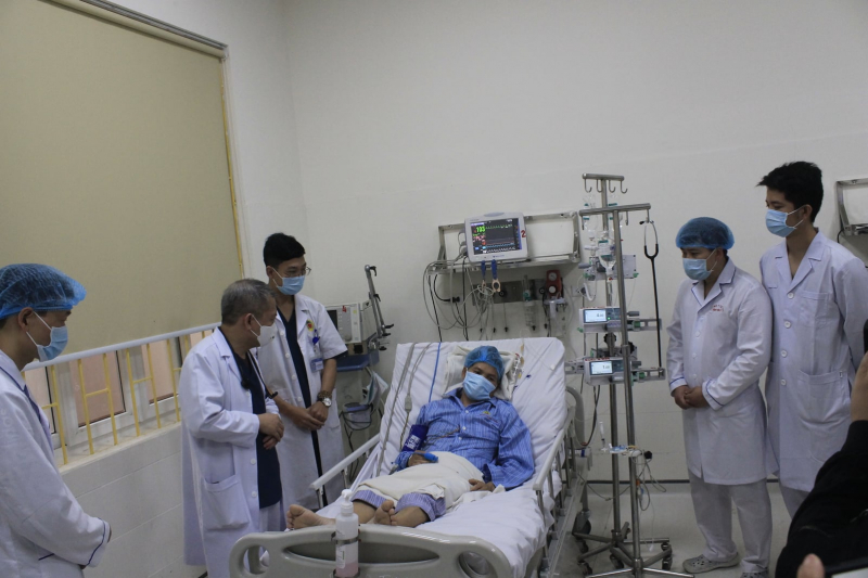 Medical staff of Hanoi E Hospital examine a patient being treated