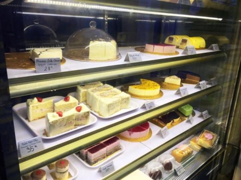 Cake counter with a variety of cakes and sizes