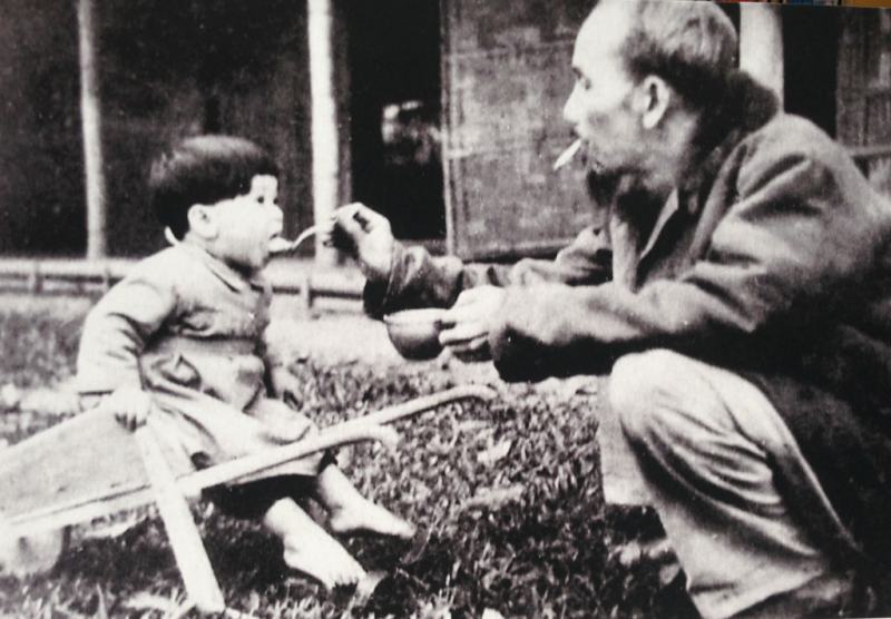 Uncle Ho feeds the baby while visiting a children's camp in Viet Bac, 1950