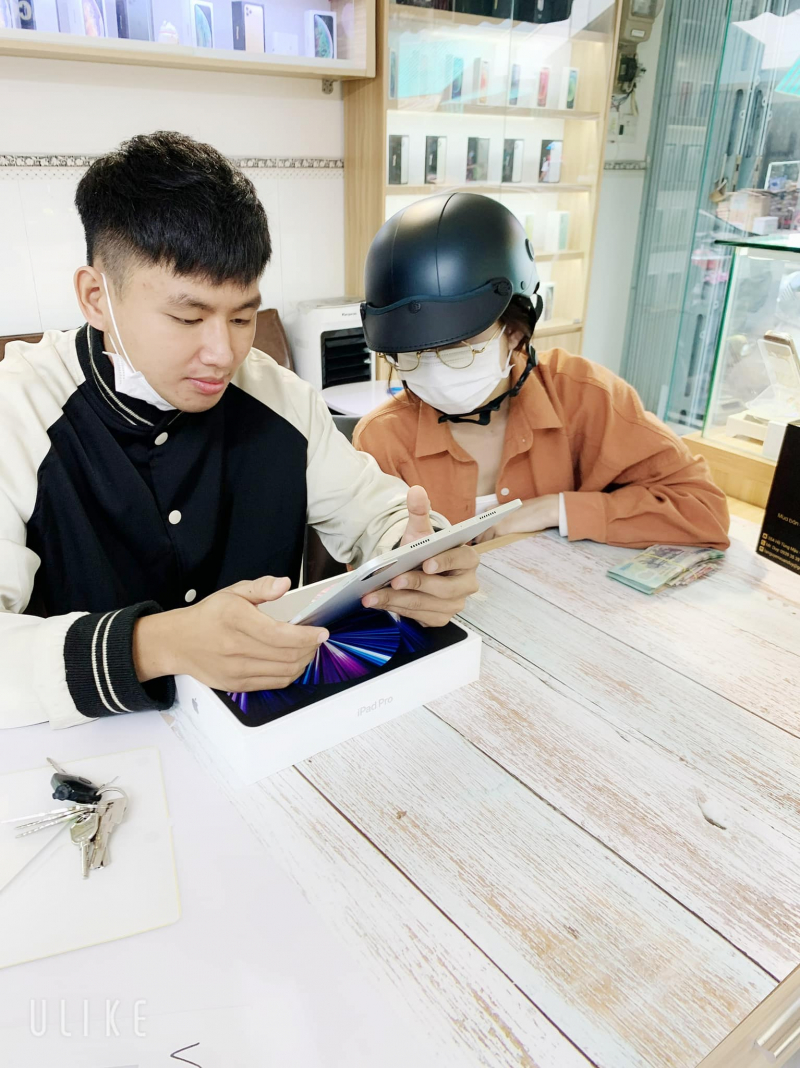 Customers test products at Duy Apple iPhone