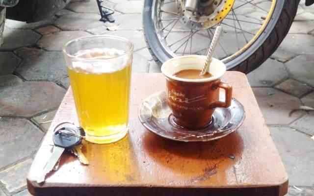 Sip a cup of hot tea or coffee watching the streets of Hanoi